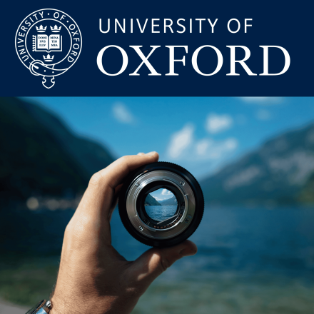 Hand holding camera lens over lake scene